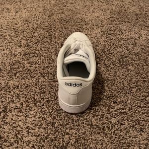 Women’s white and black Adidas sneakers